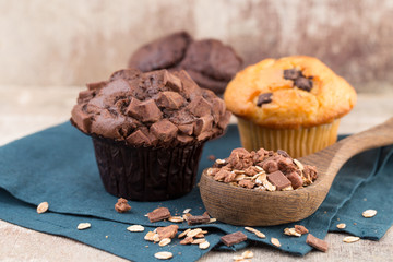 Homemade muffins with chocolate, vintage background.