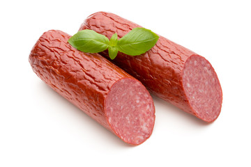 Salami smoked sausage, basil leaves on white background cutout.