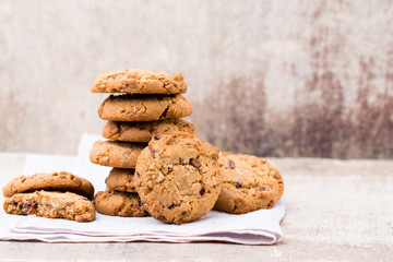 Chocolate oatmeal cookies on the wooden background.
