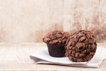 Homemade muffins with chocolate, vintage background.