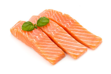 Fresh salmon fillet with basil on the white background.