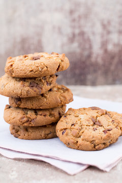 Chocolate oatmeal cookies on the wooden background.