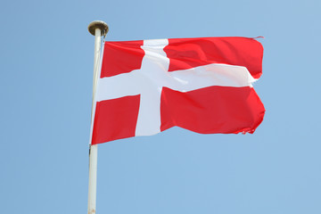 Fototapeta na wymiar Danemark flag on a mat in the wind and blue sky