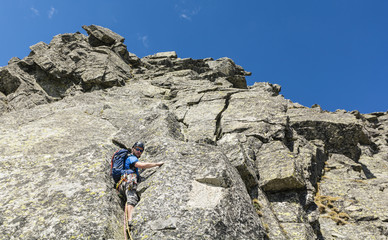 Climber in offwidth, while leading the pitch in the mountains.