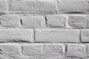 A light grey painted stone wall as texture of a background