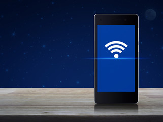Wi-fi connection icon on modern smart phone screen on wooden table over fantasy night sky and moon,...