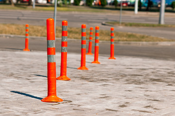 Orange traffic pillar on the road and on parking lane.