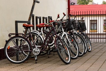 Fototapeta na wymiar city bicycles for rent stand in a row on a cobbled street of Copenhagen, Denmark