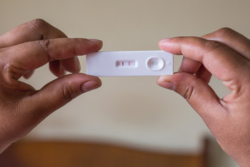 Close up of Pregnancy Tester with Hand