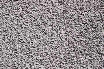 A light lilac grey painted stone wall as texture of a background
