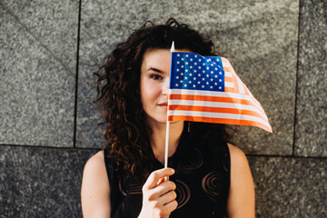 Girl with an American flag. Independence Day concept