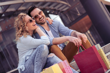 Portrait of happy couple with shopping bags