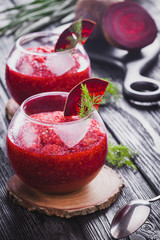 fresh vegetable smoothie from beet with dill on a black wooden table