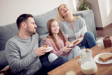 Family of three having breakfast in the morning together