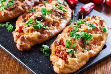 Traditional Turkish pide with meat and vegetables