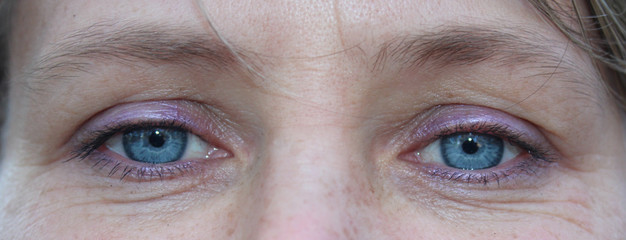 Close up of female blue eyes. Face of young woman