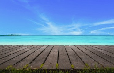 Blur cool sea background with foreground wood floor.