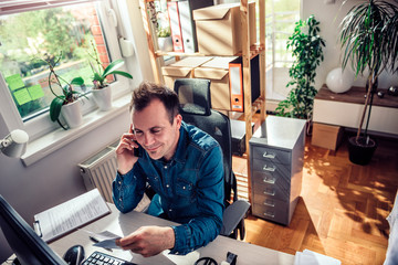 Businessman talking on the phone at the office
