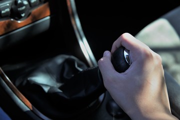 manual transmission gear shift on dark background, close-up.