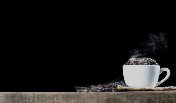 coffee beans in cup wish smoke black back ground