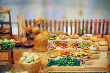The old market selling a variety of food and vegetables miniature.