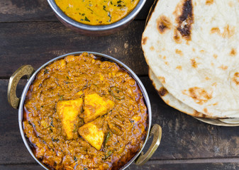 Indian Cuisine Kadai Paneer Served With Dal Makhani or Tandoori Also Know as Kadhai Paneer or Karahi Paneer is an Indian Dish of Marinated Paneer Cheese Served in a Spiced Gravy on Wooden Background