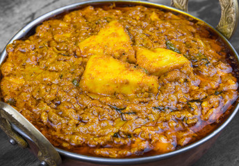 Indian Vegetarian Cuisine Kadai Paneer Also Know as Kadhai Paneer or Karahi Paneer is an Indian Dish of Marinated Paneer Cheese Served in a Spiced Gravy on Vintage Wooden Background