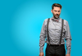 Middle age man, with beard and bow tie irritated and angry expressing negative emotion, annoyed with someone