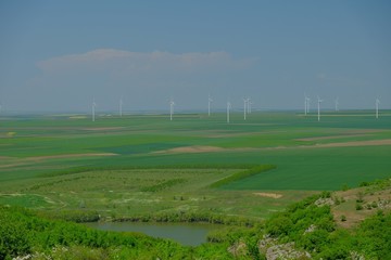 Field with wind turbines to produce green energy