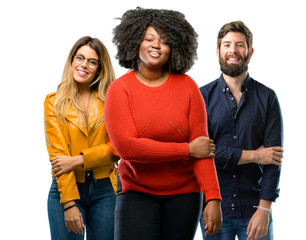 Group of three young men and women confident and happy with a big natural smile laughing