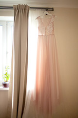Wedding dress on the hanger, bride's morning.