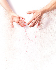 Woman and man hands with red string of fate - Dispersion effect