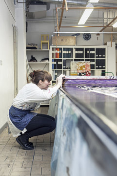 Textile designers checking the screen print frame in workshop