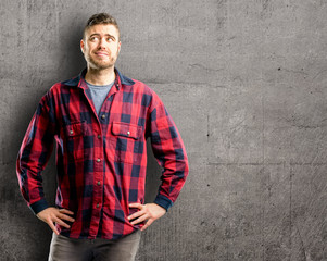 Young handsome man confident and happy with a big natural smile laughing