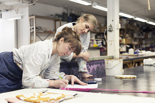 Textile designers working in workshop