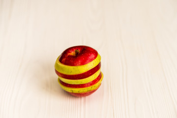 Mixed slices of red and green apple on white close