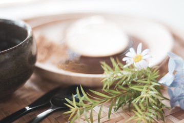 Obraz na płótnie Canvas Transparent dessert, Mochi, is blurred as a background having soft-focused flower in front