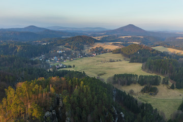 Fototapeta na wymiar View to Bohemian Switzerland National Park from from the Mariina rocky hill in the Czech Republic, located not far from Jetrichovice village at sunrise. 