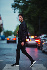 Portrait of stylish man on night city background pose to camera