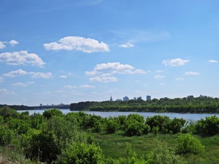 Fototapeta na wymiar City of Warsaw Panorama Hidden behind Trees across Vistula River, Warsaw, Poland