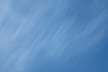 In the clear blue sky Cirrus clouds in the form of strips on diagonally. A few white blurred bands...