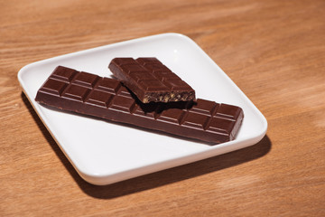 A lot of variety chocolates bar in box on white wooden background