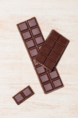 A lot of variety chocolates bar in box on white wooden background
