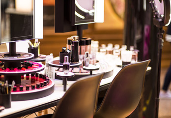 Cosmetic set on wooden dressing table with mirrors