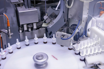 The production line of the medicine. Filling interferon in bottl
