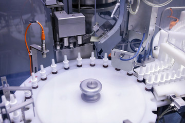 The production line of the medicine. Filling interferon in bottl