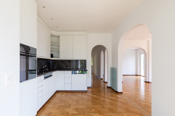 Modern white kitchen in a renovated villa