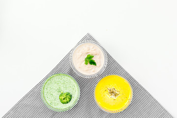 Healthy organic vegetarian meal. Cream soup concept. Colored soups with pumpkin, broccoli,...