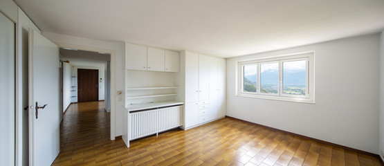 Spacious rooms with large white wardrobes.