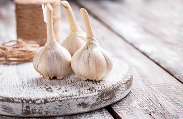 Fresh garlic on light wooden background